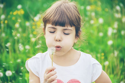 Close-up of girl blowing bubbles