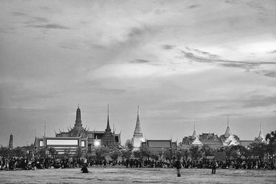 People at temple against sky