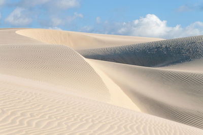 Sand dune in desert against sky