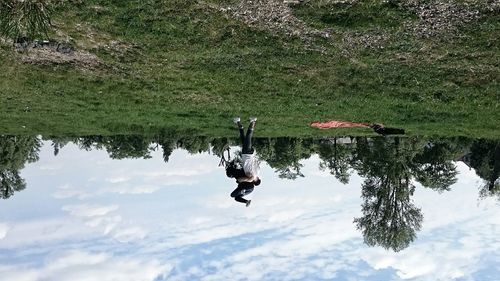 Low angle view of people on tree against sky