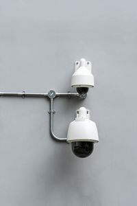 Close-up of security cameras mounted on wall