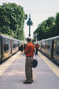 Woman walking on railroad track