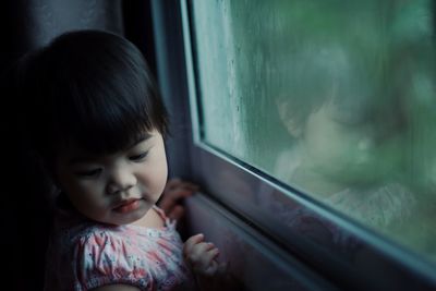 Close-up of cute girl sitting in train