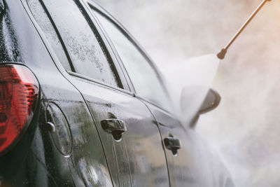 Close-up of water splashing on car 