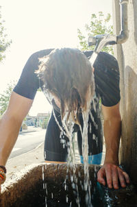 Side view of man holding water