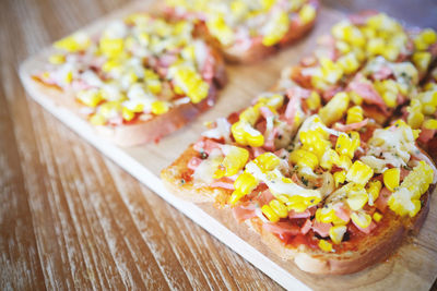 Close-up of open faced sandwich on cutting board