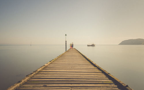 Pier over sea against clear sky