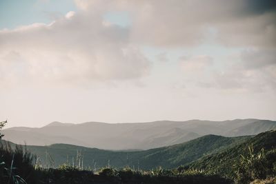 Scenic view of landscape and mountains against sky