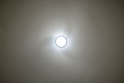 Low angle view of illuminated electric lamp