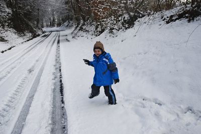 Full length of man standing on snow covered snowcapped mountains