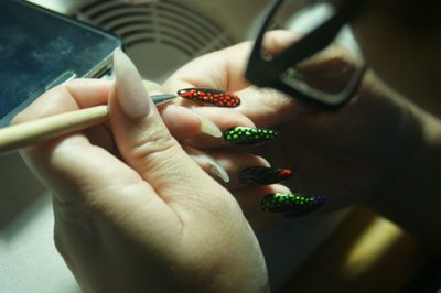 Cropped image of woman hands painting fingernails