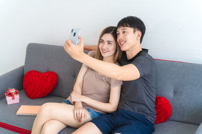 Young couple sitting on sofa