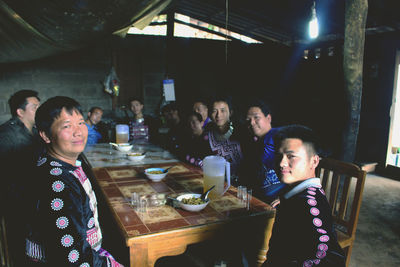 Portrait of friends sitting at restaurant