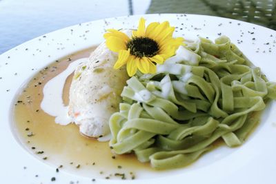 Close-up of food with yellow flower served in plate