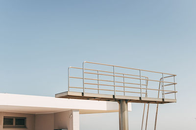 Part of diving tower in front of blue sky