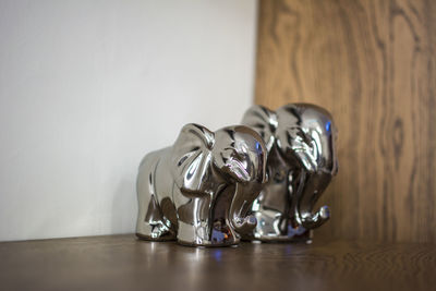 Close-up of metal elephant figurines on table