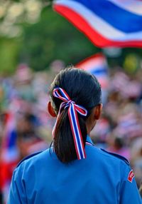 Rear view of girl with pony tail at parade