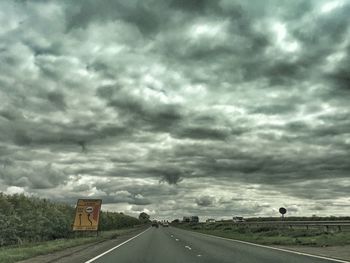 Empty road along countryside landscape