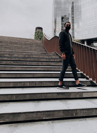 Low angle view of man standing on staircase