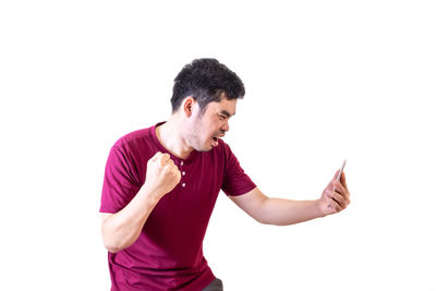 Young man standing against white background