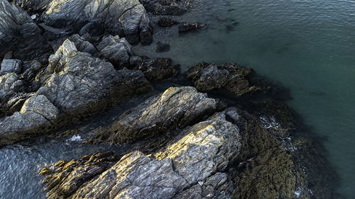 High angle view of rocks in sea