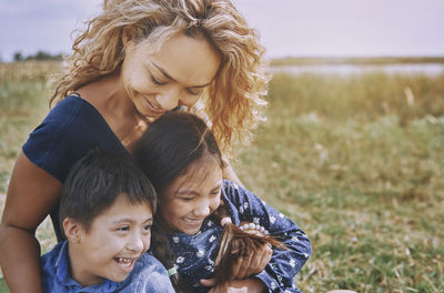 Mother playing with daughter and son