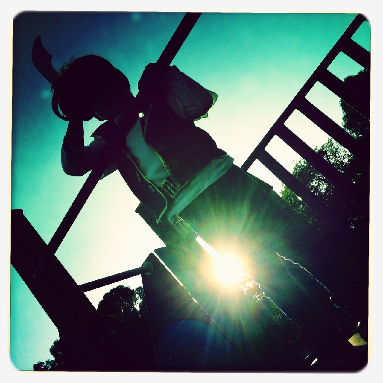 low angle view, transfer print, sun, auto post production filter, sunbeam, sky, sunlight, lens flare, silhouette, sculpture, built structure, day, outdoors, sunny, no people, back lit, statue, metal, architecture, clear sky