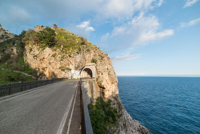 Road by sea against sky