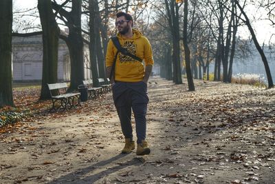 Full length of young man standing in forest