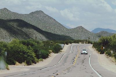 Country road leading towards mountains