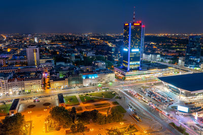 High angle view of city lit up at night