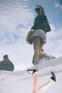 Reflection of woman in puddle