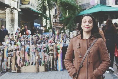 Portrait of woman standing against street market