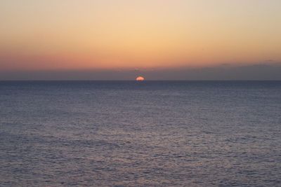 Scenic view of sea against clear sky during sunset