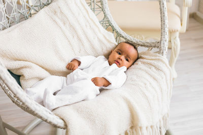 Cute baby girl lying on bed