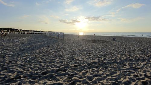 Scenic view of beach against sky during sunset