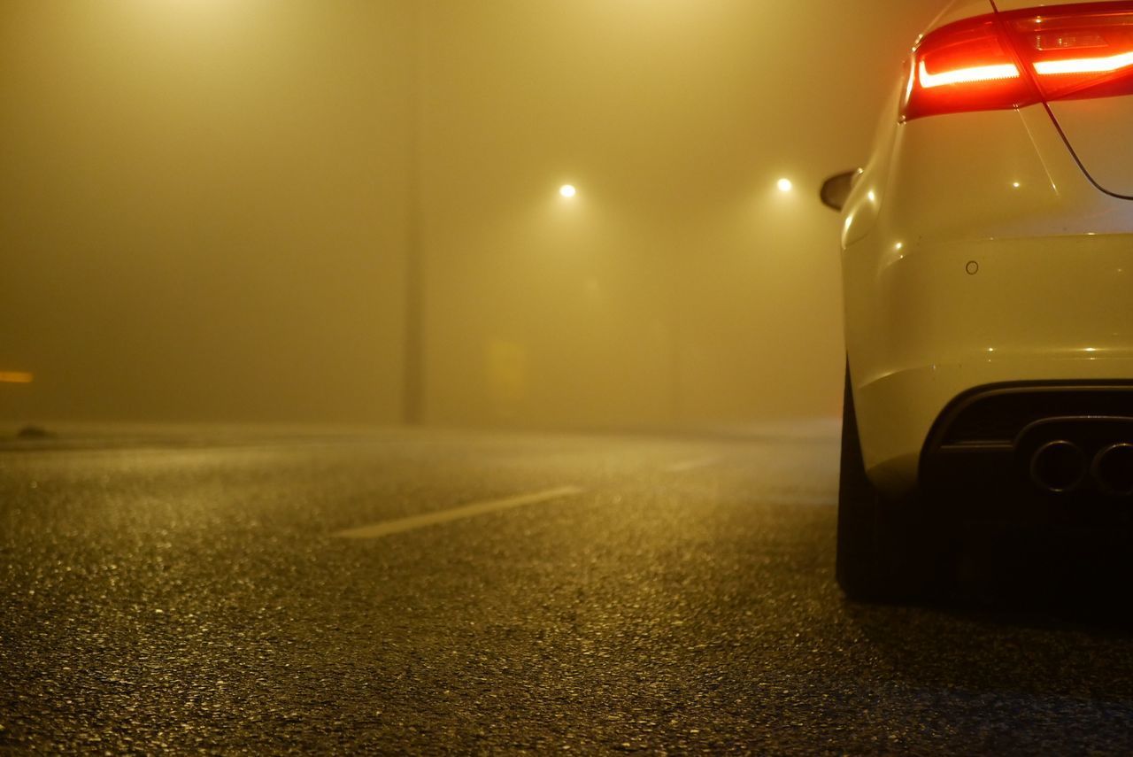 CLOSE-UP OF YELLOW CAR ON ROAD