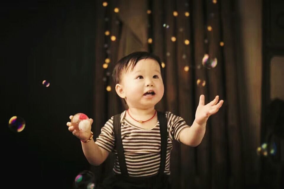 CLOSE-UP OF A BABY BOY IN A HAND