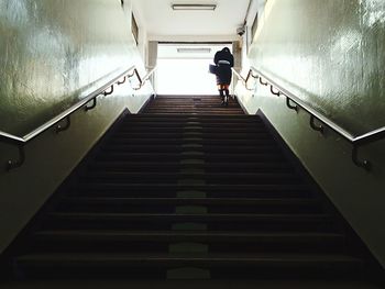 Low angle view of woman walking in staircase