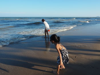 Full length of woman on beach against sky