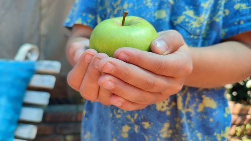 Child holding an apple