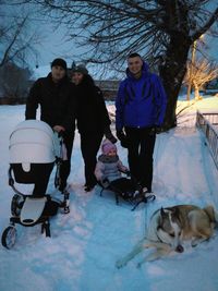 People with dog on snow