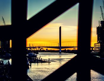 View of bridge over sea at sunset