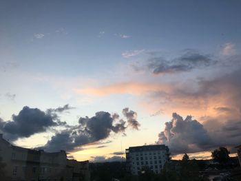 Smoke emitting from factory against sky during sunset