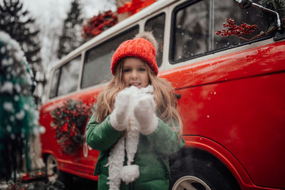 Portrait of smiling young woman holding car