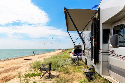 Camper van against sea or ocean kite surfers camp spot
