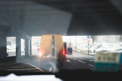 Road in city seen through car windshield