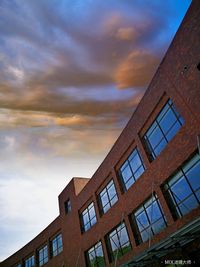 Low angle view of buildings against sky during sunset