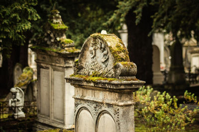 Statue of old temple against building