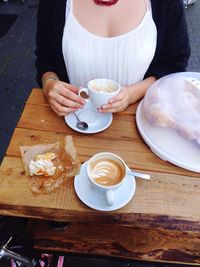 Woman drinking coffee at caf